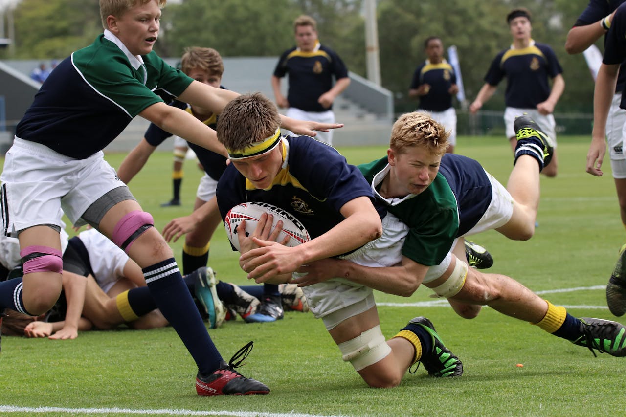 Players in team sportswear on a green pitch